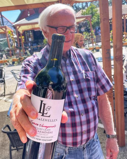 Lucas & Lewellen owner Louis Lucas holding a bottle of Lucas & Lewellen Carmenere