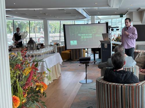 Mike Lewellen conducting a wine tasting and history of Normandy wines on the AMAWaterways photo by T