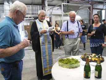 Father John Finley blesses the Lucas & Lewellen harvest