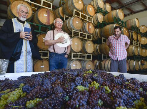 Photo by Len Wood of Father John Finley blessing the first fruits of the Lucas & Lewellen grape harvest Photo by Len Wood of Father John Finley blessing the first fruits of the Lucas & Lewellen grape harvest