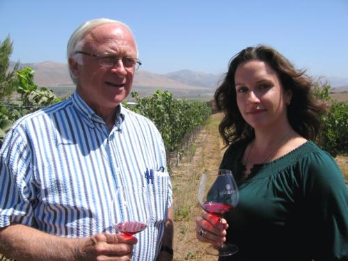 Louis Lucas and Megan McGrath Gates with wine in a vineyard
