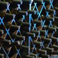A photo of a wine cellar with wines stacked in a rack A photo of a wine cellar with wines stacked in a rack
